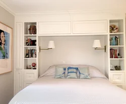 Bed between wardrobes in bedroom design