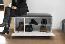 Shoe racks in the hallway with a seat and a drawer photo