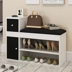 Shoe racks in the hallway with a seat and a drawer photo