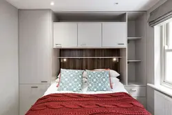 Small bedroom with a large bed and wardrobe photo