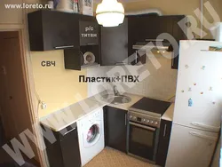 Kitchen in Khrushchev with a water heater and a washing machine photo