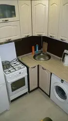 Kitchen in Khrushchev with a water heater and a washing machine photo