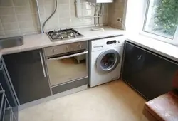 Kitchen in Khrushchev with a water heater and a washing machine photo