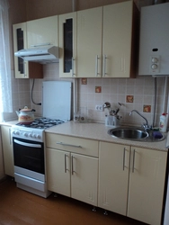 Kitchen 6 sq m with gas water heater and refrigerator photo