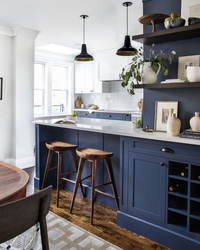 Blue kitchen with wooden countertops in the interior photo