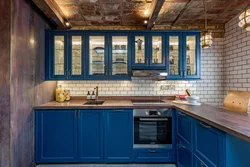 Blue kitchen with wooden countertops in the interior photo