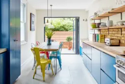 Blue kitchen with wooden countertops in the interior photo