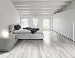 What kind of floors are in the bedroom photo