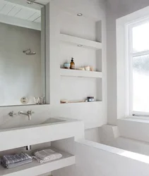 Niche with shelves near the bathtub photo