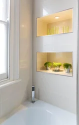 Niche with shelves near the bathtub photo