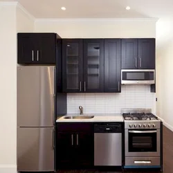Photo of a kitchen with a right corner and a refrigerator
