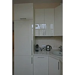 Photo of a kitchen with a right corner and a refrigerator