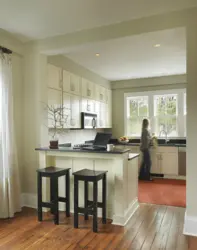 Photo of a kitchen in a house with a window and a bar counter