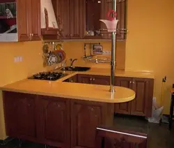 Photo of a kitchen with bar counters all made of wood