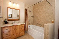 Bathtub with decorative plaster and tiles photo