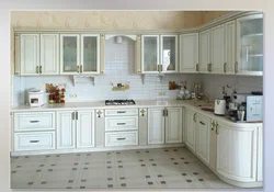 Photo of a white kitchen with wooden walls