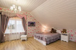 Bedroom in the attic of a wooden house with a sloping ceiling photo