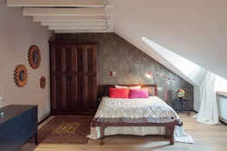 Bedroom in the attic of a wooden house with a sloping ceiling photo