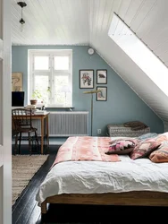 Bedroom In The Attic Of A Wooden House With A Sloping Ceiling Photo