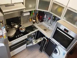 Kitchen with refrigerator and washing machine photo