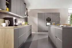 Gray kitchen with a wooden countertop and a wood-effect apron photo