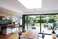Photo kitchen living room in a house with panoramic windows