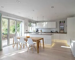 Photo kitchen living room in a house with panoramic windows