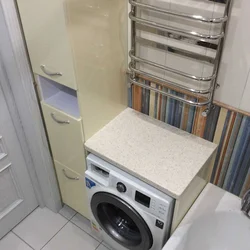 Built-in washing machine in the bathroom in the closet photo