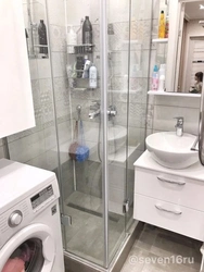 Photo of a small bathroom with shower and washing machine
