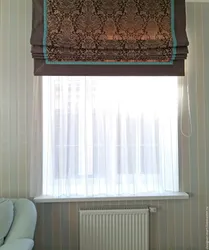 Roman blinds in the kitchen interior with tulle