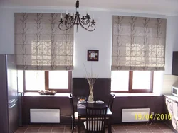 Roman blinds in the kitchen interior with tulle