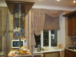 Roman blinds in the kitchen interior with tulle