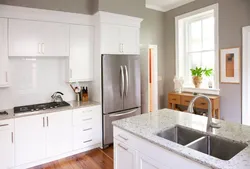 Kitchen with gray walls and white furniture photo