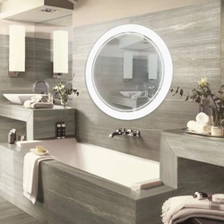 Round mirror in the bathroom interior