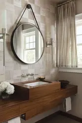 Round mirror in the bathroom interior