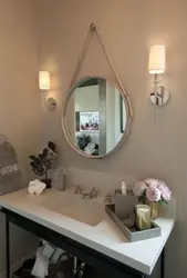 Round mirror in the bathroom interior