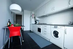 Kitchen with washing machine and stove photo