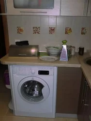 Kitchen with washing machine and stove photo