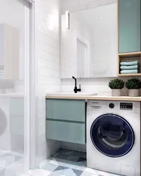 Bathtub and washing machine in a small bathroom photo