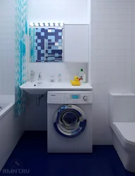 Bathtub and washing machine in a small bathroom photo