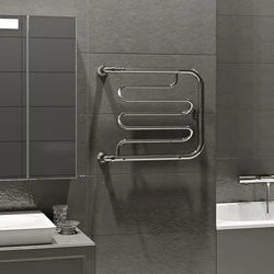 Heated towel rail in the bathroom interior