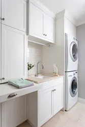 Washer and dryer in a column in the bathroom interior