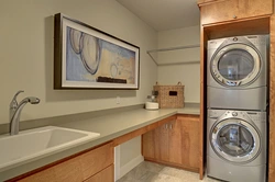 Washer and dryer in a column in the bathroom interior