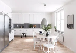 White kitchen with gray floor in the interior