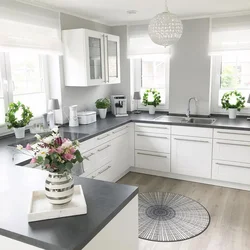 White kitchen with gray floor in the interior