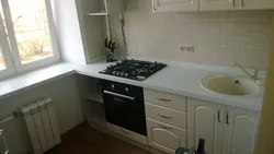 Gas stove by the window in the kitchen interior