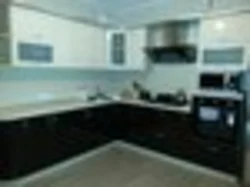 Photo of a kitchen with a black panel