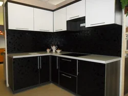 Photo of a kitchen with a black panel