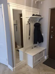 Shoe rack and mirror in the hallway in the interior