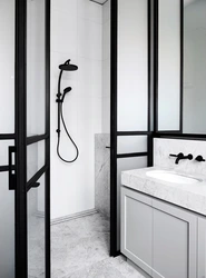 Black bathtub faucets in the interior photo